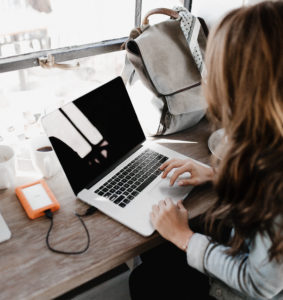 A woman using a laptop.